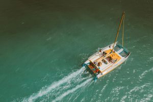 A catamaran sailing into the sea - Luxury Yacht Rental Cancun