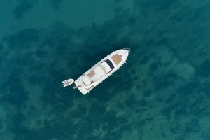 An aerial view of a yacht sailing in the middle of the sea - Luxury Yacht Rental Cancun