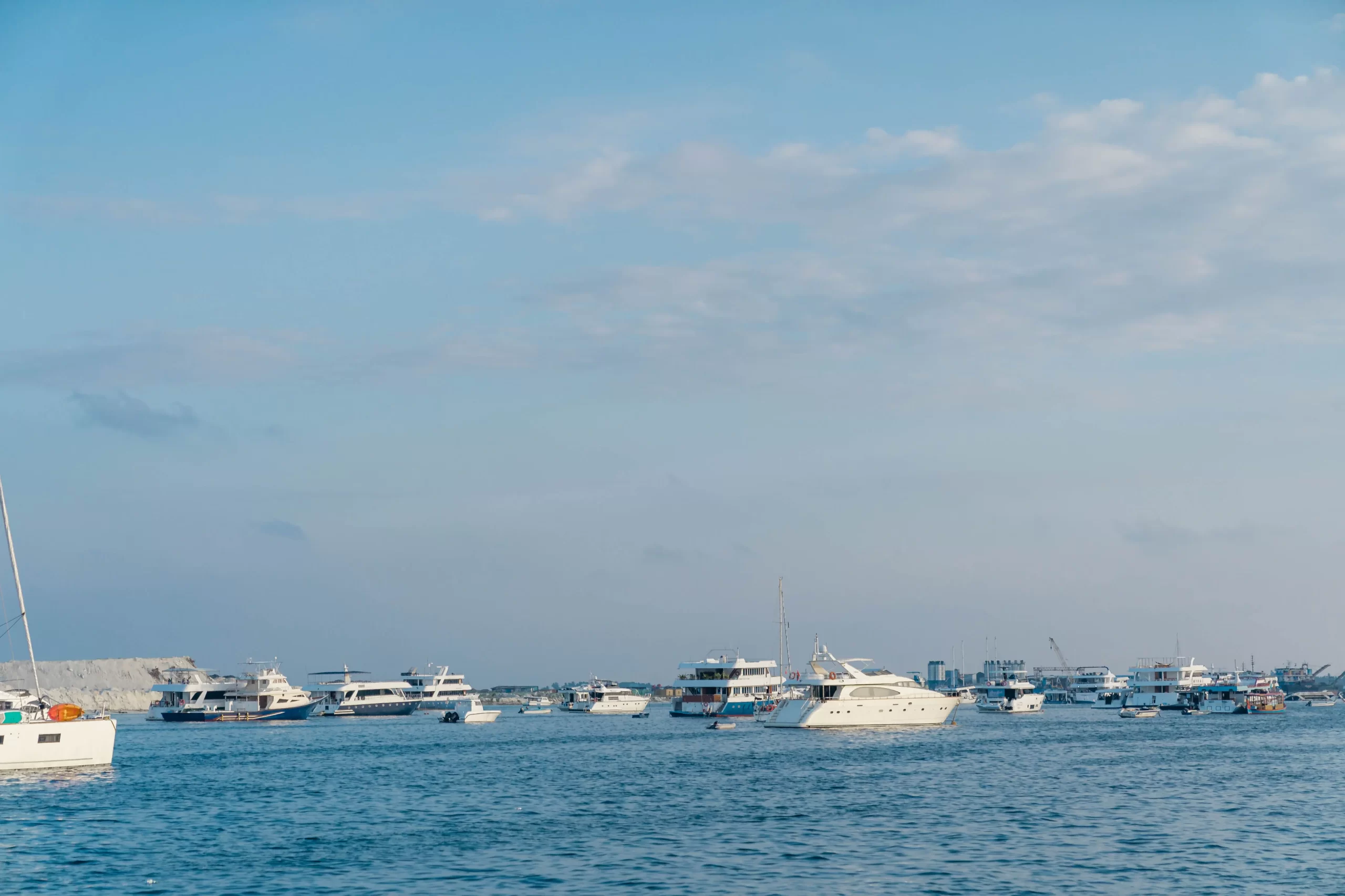 Luxury yachts and boats on the water in Cancun, representing superyacht charter options, onboard services, and private cruising experiences.